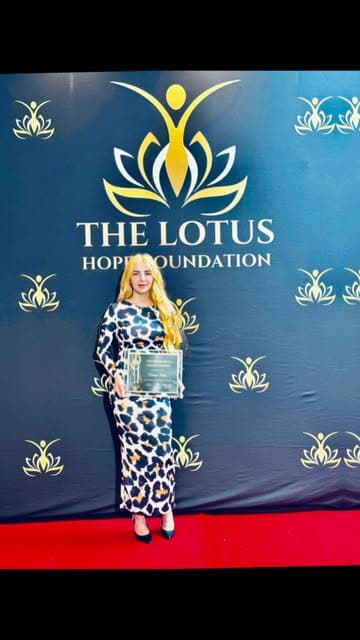 Caleesis Telesh holding her recognition at the Lotus Hope Impact Awards