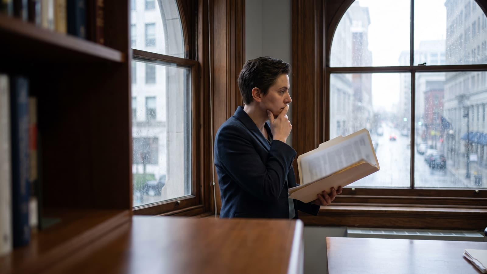 Person at a desk with contracts, invoices and a calendar spread out, working out whether to start a lawsuit