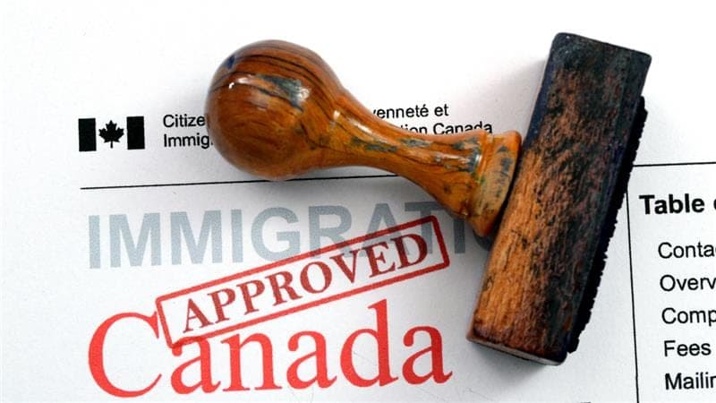 An approved stamp across an Immigration Canada application form