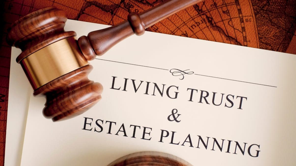 A gavel resting on a Living Trust and Estate Planning document
